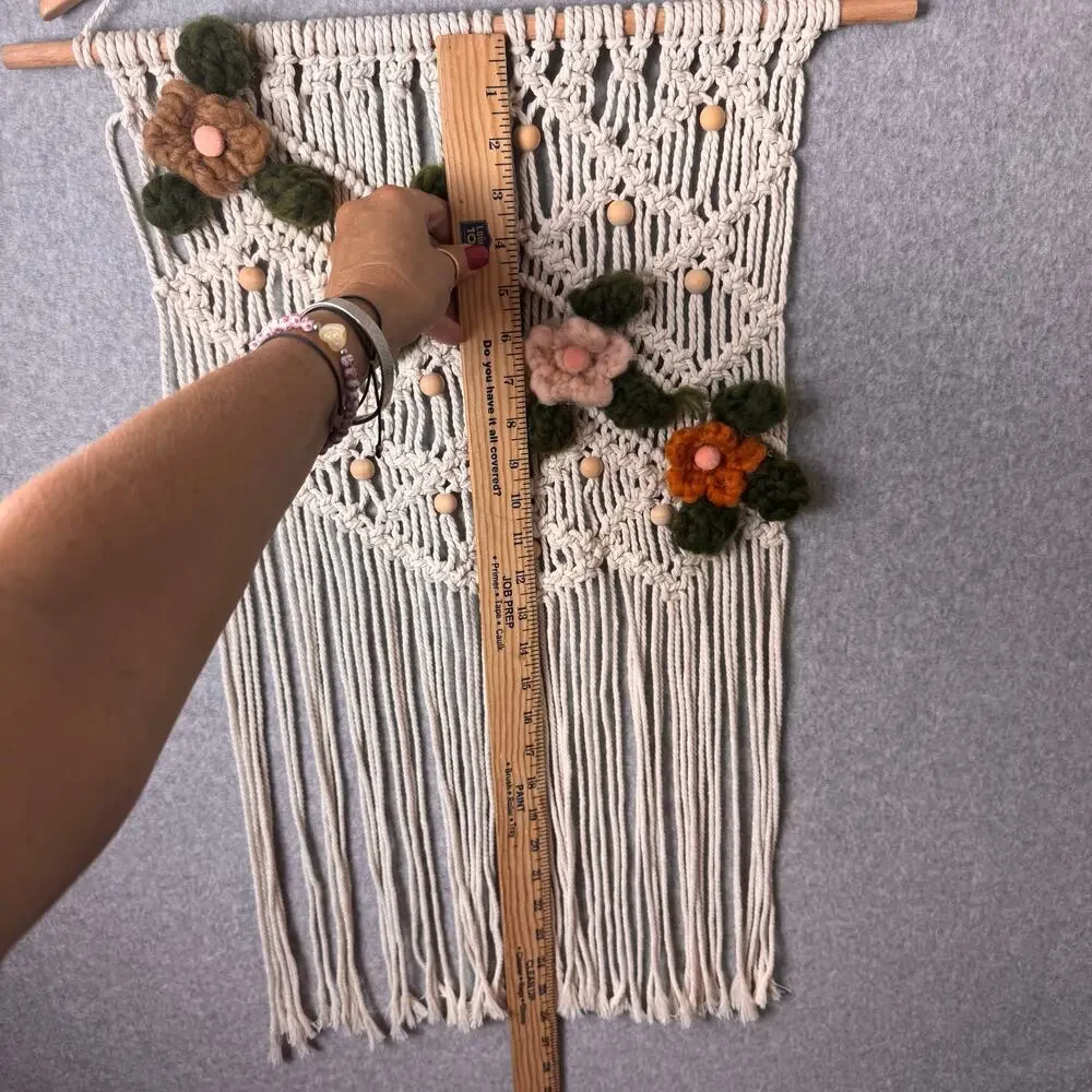 handmade boho-style macramé wall hanging crocheted flowers wooden beads fringe